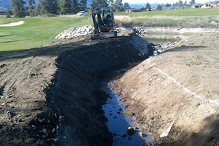 Excavating a drainage ditch